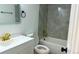 Stylish bathroom with white vanity, gray tile shower, and modern gold fixtures at 2218 Coronado N Pkwy # B, Denver, CO 80229