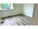 Light-filled bedroom with sleek flooring and a large window providing natural light at 2218 Coronado N Pkwy # B, Denver, CO 80229