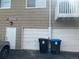 Apartment garages featuring refuse bins and a warning sign at 2218 Coronado N Pkwy # B, Denver, CO 80229