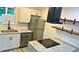 Modern kitchen with new appliances, center island with flat cooktop and new countertops at 2218 Coronado N Pkwy # B, Denver, CO 80229