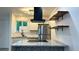Modern kitchen with stainless steel appliances, floating shelves, and stylish backsplash at 2218 Coronado N Pkwy # B, Denver, CO 80229
