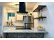 Updated kitchen features stainless appliances, floating shelves and a center island cooktop at 2218 Coronado N Pkwy # B, Denver, CO 80229