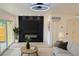Cozy living room featuring a modern fireplace, shiplap accent wall and lots of natural light at 2218 Coronado N Pkwy # B, Denver, CO 80229