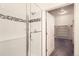 Modern bathroom shower with glass door and tiled walls leading to walk-in closet at 4533 Angelina Cir, Longmont, CO 80503