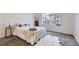 Bright, minimalist bedroom featuring a plush rug, and a large window at 4533 Angelina Cir, Longmont, CO 80503
