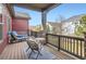 Relaxing covered deck with comfortable seating, a table, and a pleasant neighborhood view at 4533 Angelina Cir, Longmont, CO 80503