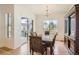 Formal dining room with large windows, stylish chandelier, and ample natural light at 4533 Angelina Cir, Longmont, CO 80503