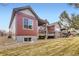 Charming home featuring a covered deck, stone accents, and well-maintained landscaping in a residential neighborhood at 4533 Angelina Cir, Longmont, CO 80503