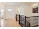 Bright foyer with tile flooring, white walls, and stairs with decorative black iron railing at 4533 Angelina Cir, Longmont, CO 80503