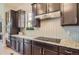 Modern kitchen with dark wood cabinets, stainless steel appliances, and granite countertops at 4533 Angelina Cir, Longmont, CO 80503