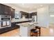 Modern kitchen with stainless steel appliances, granite countertops, and a center island with bar seating at 4533 Angelina Cir, Longmont, CO 80503