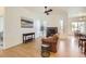 Bright open-concept living room with a fireplace, hardwood floors, and neutral paint at 4533 Angelina Cir, Longmont, CO 80503