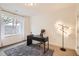 Bright home office with a large window, modern desk, and stylish lighting perfect for productivity at 4533 Angelina Cir, Longmont, CO 80503