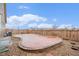 Exterior view of backyard featuring a unique stone patio, fence, and gravel landscaping at 5521 Ensenada St, Denver, CO 80249