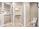 Bathroom featuring a tiled walk-in shower, toilet, and walk-in closet at 5521 Ensenada St, Denver, CO 80249