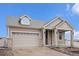 Charming home featuring stone accents, manicured landscaping, and an attached two-car garage at 5521 Ensenada St, Denver, CO 80249