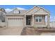 Charming home featuring stone accents, manicured landscaping, and an attached two-car garage at 5521 Ensenada St, Denver, CO 80249