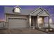 Inviting two-story home boasts a well-manicured lawn and an attached two-car garage at 5521 Ensenada St, Denver, CO 80249