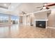 Spacious open living room featuring a cozy fireplace and sliding door access to a backyard patio at 5521 Ensenada St, Denver, CO 80249