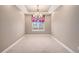 Cozy room featuring a large window with decorative curtains and an elegant chandelier at 5521 Ensenada St, Denver, CO 80249
