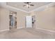 Spacious main bedroom with ceiling fan and doors leading to en-suite bathroom and closet at 5521 Ensenada St, Denver, CO 80249