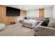 Basement media room with a large sectional sofa, accent wall and big screen TV for entertaining at 43 Falcon Hills Dr, Highlands Ranch, CO 80126