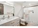 Bright bathroom featuring a white vanity, modern fixtures, and a tiled shower with glass door at 43 Falcon Hills Dr, Highlands Ranch, CO 80126