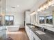 Luxurious bathroom featuring a soaking tub, double vanity and lots of natural light at 43 Falcon Hills Dr, Highlands Ranch, CO 80126