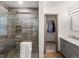 Stylish bathroom showcasing a glass-enclosed shower, modern vanity, and seamless access to a closet at 43 Falcon Hills Dr, Highlands Ranch, CO 80126