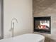 Elegant bathroom with a freestanding tub next to a fireplace and a sleek faucet at 43 Falcon Hills Dr, Highlands Ranch, CO 80126