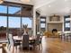 Bright dining area features large windows, a cozy fireplace, and beautiful hardwood floors at 43 Falcon Hills Dr, Highlands Ranch, CO 80126