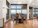 Elegant dining room with large windows offering panoramic views, hardwood floors and modern lighting at 43 Falcon Hills Dr, Highlands Ranch, CO 80126
