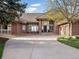 Inviting brick home showcasing a long driveway and well-manicured lawn at 43 Falcon Hills Dr, Highlands Ranch, CO 80126