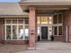 Stunning front entry with brick accents, large windows, and a stylish black front door at 43 Falcon Hills Dr, Highlands Ranch, CO 80126