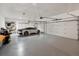 Spacious three car garage with epoxy floors, built in storage, and car charging station at 43 Falcon Hills Dr, Highlands Ranch, CO 80126