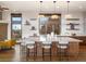 Bright kitchen with a stylish island featuring seating, open shelving, and scenic views at 43 Falcon Hills Dr, Highlands Ranch, CO 80126