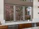 Kitchen sink below window with stainless steel appliances and a view of blooming trees outside at 43 Falcon Hills Dr, Highlands Ranch, CO 80126