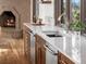 Kitchen sink with quartz countertop with an elegant view of the fireplace at 43 Falcon Hills Dr, Highlands Ranch, CO 80126