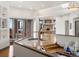 Bright and open living space showcasing hardwood floors and views into kitchen and backyard at 43 Falcon Hills Dr, Highlands Ranch, CO 80126