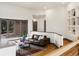 Cozy living room with a comfortable sofa, hardwood floors, and backyard views at 43 Falcon Hills Dr, Highlands Ranch, CO 80126
