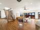 Open-concept living room with hardwood floors, modern staircase, stylish seating and access to outdoor deck with view at 43 Falcon Hills Dr, Highlands Ranch, CO 80126