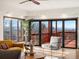 Bright living room featuring hardwood floors, stylish seating, and sliding glass doors to a deck with beautiful views at 43 Falcon Hills Dr, Highlands Ranch, CO 80126