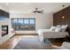 Spacious bedroom with a fireplace, large windows and bright natural light at 43 Falcon Hills Dr, Highlands Ranch, CO 80126