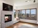 Cozy bedroom with a warm fireplace and scenic views from the windows at 43 Falcon Hills Dr, Highlands Ranch, CO 80126