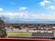 This home boasts stunning views of the mountains and valley, framed by mature trees and a beautiful sky at 43 Falcon Hills Dr, Highlands Ranch, CO 80126