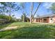 Large backyard with a grassy lawn and a covered brick patio visible at the back of the house at 1269 N Revere St, Aurora, CO 80011