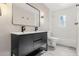 Modern bathroom with double sink vanity, a large mirror, and a shower with white tiles at 1269 N Revere St, Aurora, CO 80011