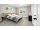 Serene bedroom with neutral decor, natural light, and wood-like flooring, complemented by stylish furnishings at 1269 N Revere St, Aurora, CO 80011