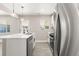 Bright kitchen featuring an island with a sink, stainless steel appliances, and white cabinets at 1269 N Revere St, Aurora, CO 80011