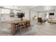 Open concept living space featuring a modern kitchen, dining area, and cozy lounge with neutral tones at 1269 N Revere St, Aurora, CO 80011